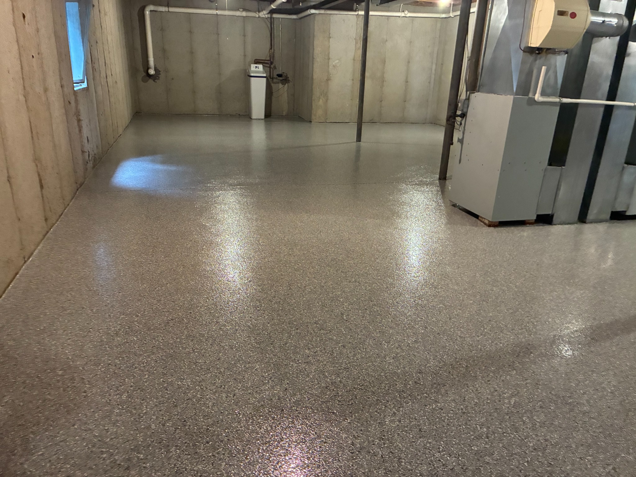 Finished flake epoxy flooring around basement utility area
