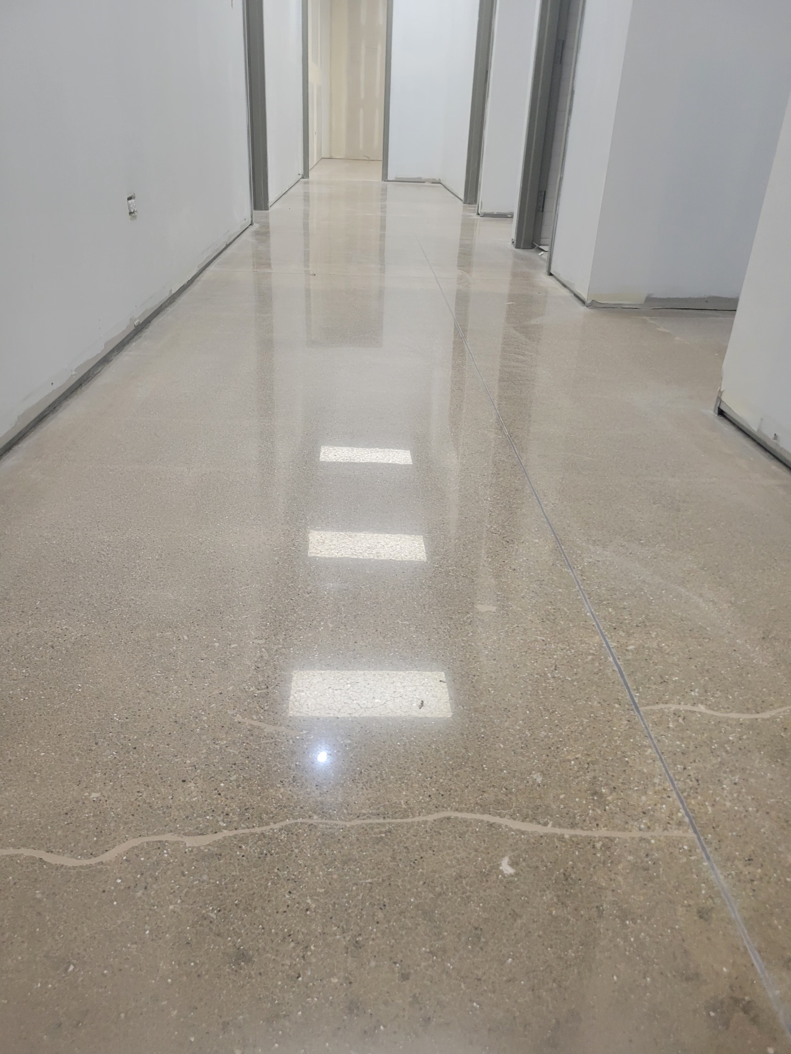 Polished concrete hallway by J&J Custom Flooring